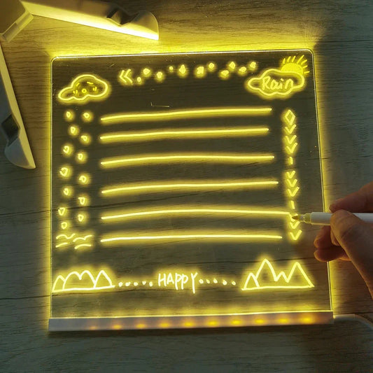 Lousa de vidro LED iluminada com desenhos amarelos e espaço para notas.